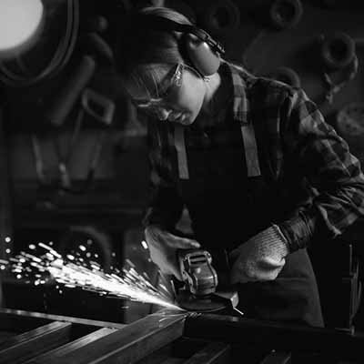 Woman welding double rim backboard
