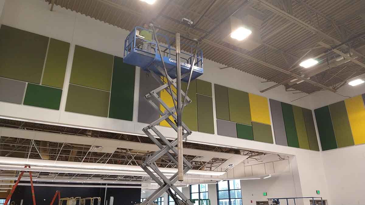 Installing basketball goal at School of Science and Technology Northeast High School