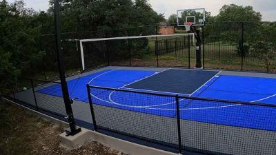 Game court with Sport Court® surface, basketball goal and multi-sport game net in Garden Ridge, Texas.