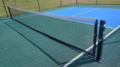 Pickleball net on pickleball court in Boerne, Texas. Court features Sport Court® Sport Game PB surface for pickleball.